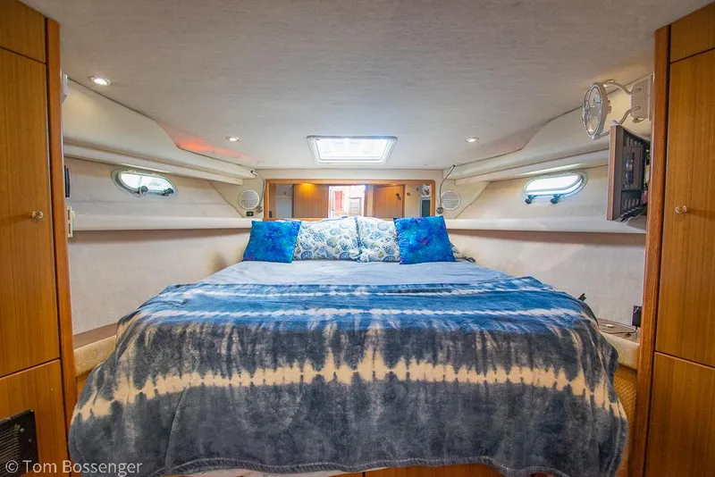 Slide: The Image of Luxurious bedroom interior of 2002 Bayliner 3988 Command Bridge Motoryacht with cozy bedding. - 22