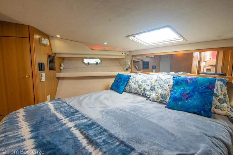 Slide: The Image of Cozy bedroom in 2002 Bayliner 3988 Command Bridge Motoryacht with blue accents and natural light. - 23