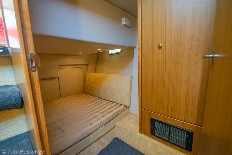 Slide: The Image of Cozy cabin interior of 2002 Bayliner 3988 Command Bridge Motoryacht with wood paneling. - 28