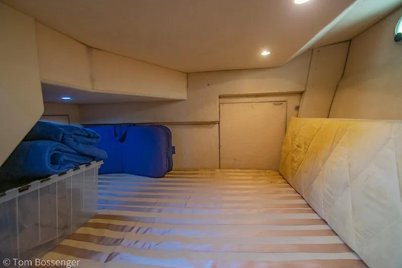 Slide: The Image of Cozy cabin interior of 2002 Bayliner 3988 Command Bridge Motoryacht with storage and bedding. - 29