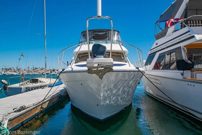 Slide: The Image of 2002 Bayliner 3988 Command Bridge Motoryacht docked at marina under clear blue sky. - 3