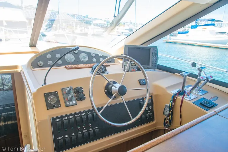 Slide: The Image of 2002 Bayliner 3988 Command Bridge Motoryacht helm with steering wheel and navigation controls. - 31