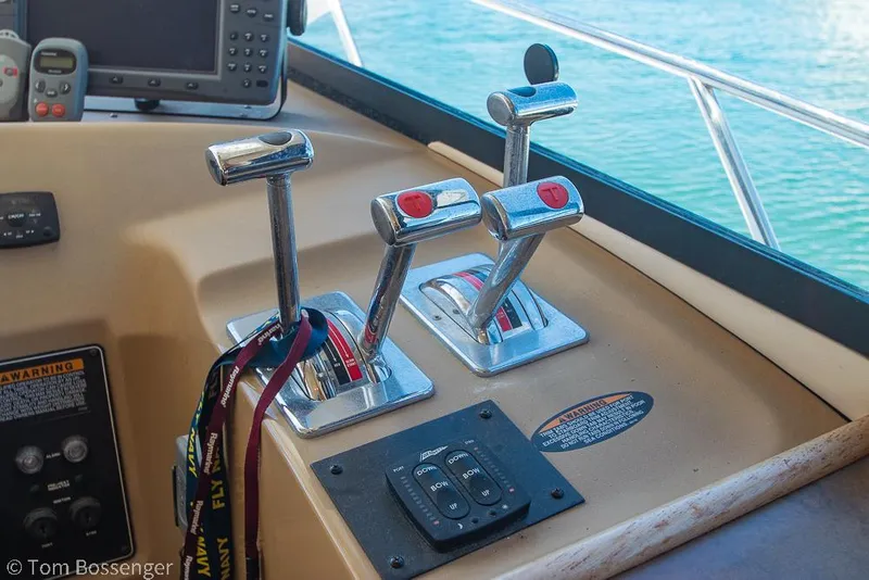 Slide: The Image of Control panel of a 2002 Bayliner 3988 Command Bridge Motoryacht with throttle levers and navigation equipment. - 34