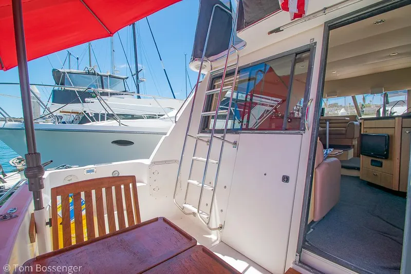 Slide: The Image of 2002 Bayliner 3988 Command Bridge Motoryacht interior with outdoor seating and ladder. - 38