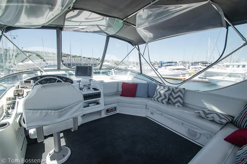 Slide: The Image of 2002 Bayliner 3988 Command Bridge Motoryacht interior with helm, seating, and marina view. - 39