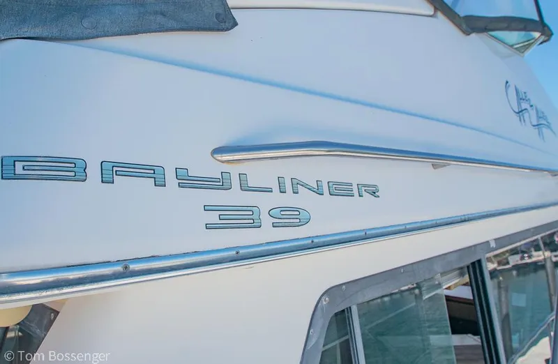 Slide: The Image of 2002 Bayliner 3988 Command Bridge Motoryacht side view with logo and windows. - 4