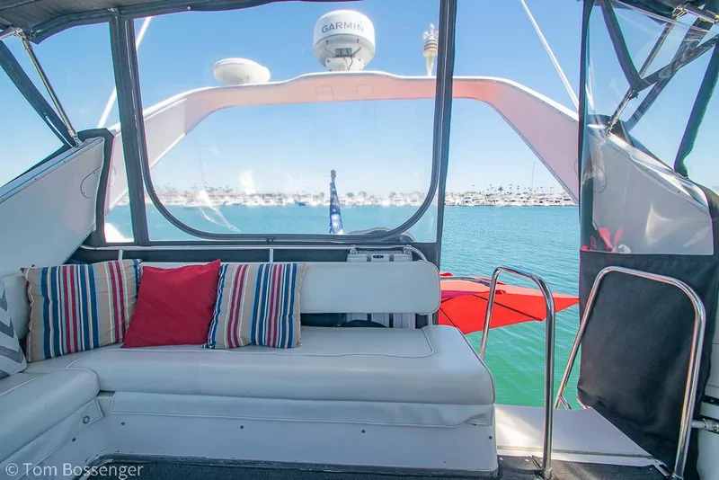 Slide: The Image of 2002 Bayliner 3988 Command Bridge Motoryacht interior with striped cushions and ocean view. - 42