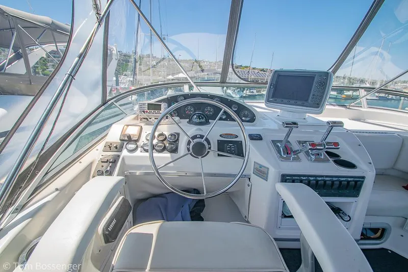 Slide: The Image of 2002 Bayliner 3988 Command Bridge Motoryacht helm with steering wheel and navigation equipment. - 43