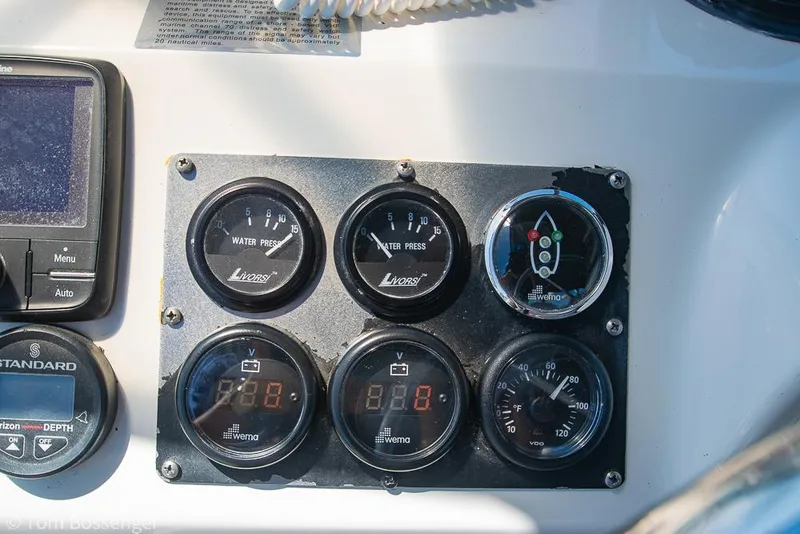Slide: The Image of Instrument panel of a 2002 Bayliner 3988 Command Bridge Motoryacht, featuring various gauges and controls. - 49