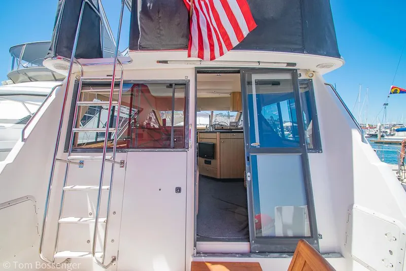 Slide: The Image of 2002 Bayliner 3988 Command Bridge Motoryacht with open cabin door and American flag. - 7