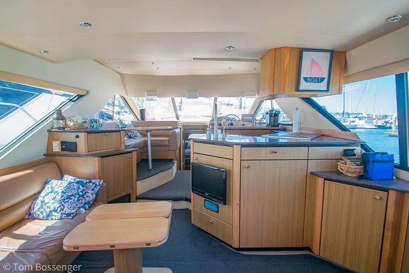 Slide: The Image of Interior of 2002 Bayliner 3988 Command Bridge Motoryacht with modern wood finish and seating area. - 8