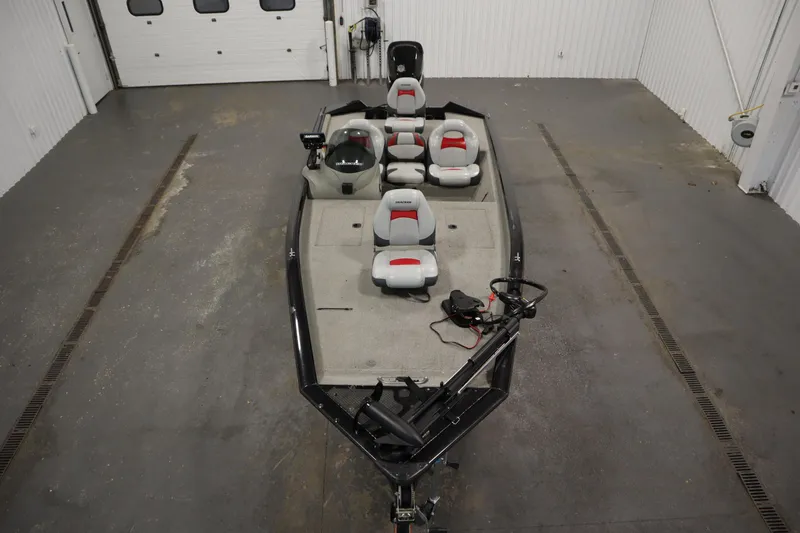 Slide: The Image of 2012 Tracker 190 TX Pro Team boat in a garage, featuring multiple seats and a trolling motor. - 10