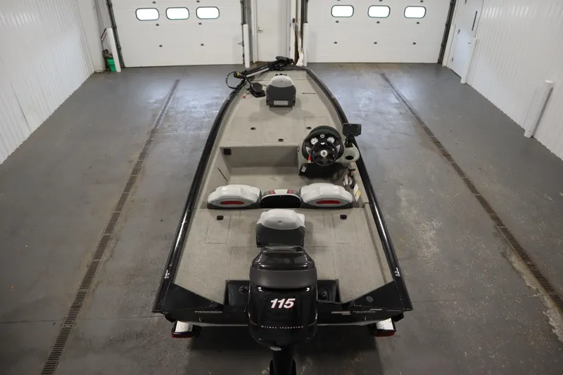 Slide: The Image of 2012 Tracker 190 TX Pro Team boat in a garage, featuring a 115 horsepower engine. - 11