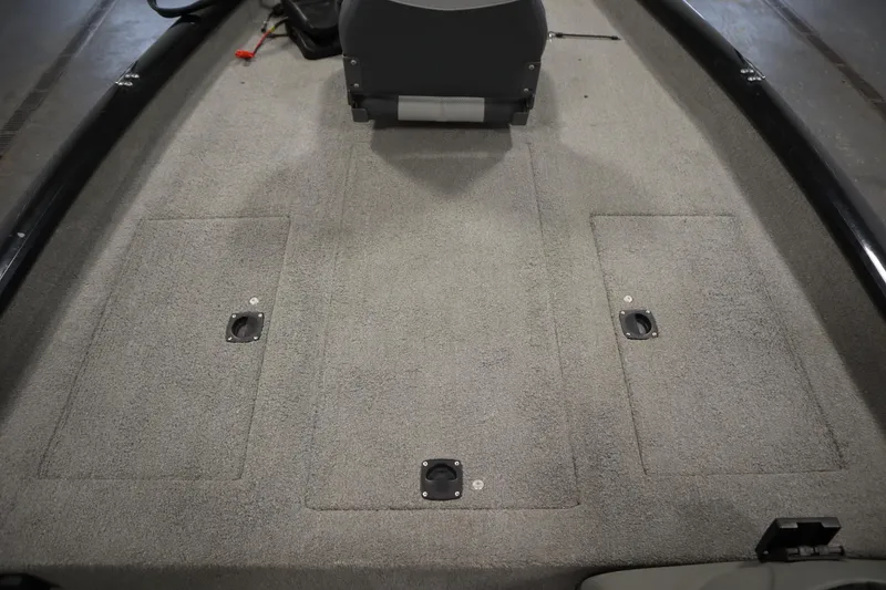 Slide: The Image of 2012 Tracker 190 TX Pro Team boat interior with carpeted deck and storage compartments. - 19