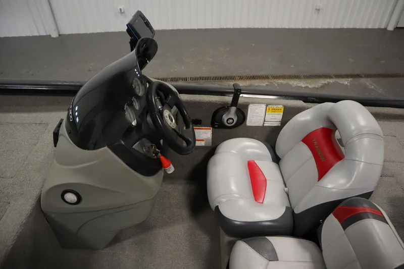 Slide: The Image of 2012 Tracker 190 TX Pro Team boat interior with steering wheel and seats. - 23