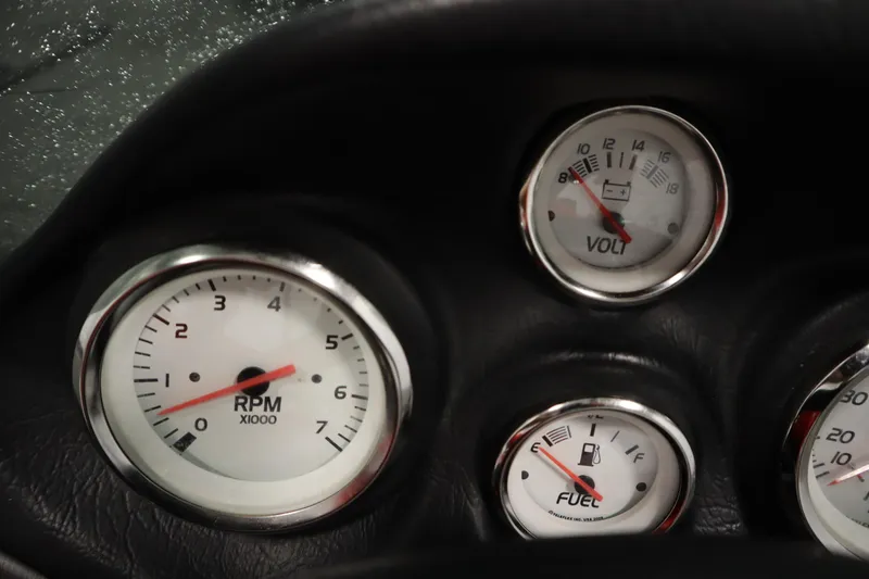 Slide: The Image of Dashboard gauges of a 2012 Tracker 190 TX Pro Team boat, showing RPM, voltage, and fuel levels. - 26