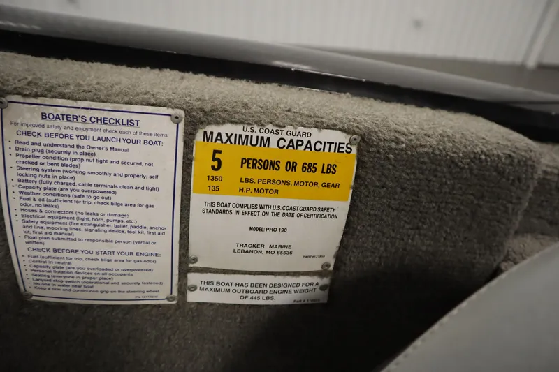 Slide: The Image of 2012 Tracker 190 TX Pro Team boat capacity label and boater's checklist. - 32