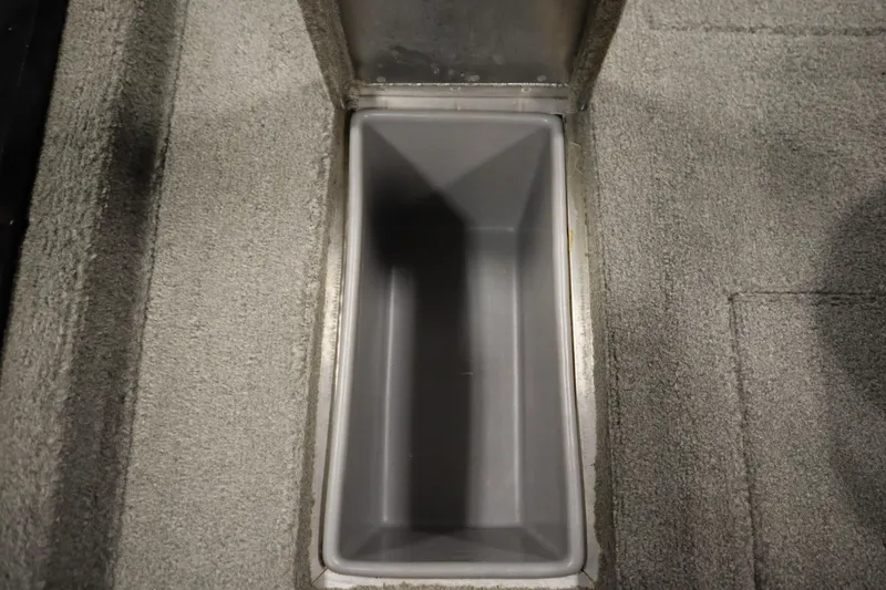 Slide: The Image of Storage compartment in 2012 Tracker 190 TX Pro Team boat, featuring gray interior and carpeted edges. - 41