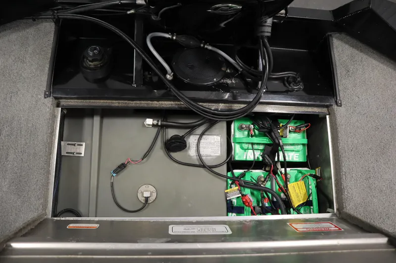 Slide: The Image of 2012 Tracker 190 TX Pro Team boat battery compartment with wiring and Interstate batteries. - 42