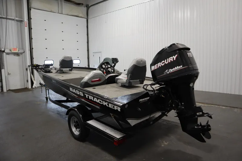 Slide: The Image of 2012 Tracker 190 TX Pro Team bass boat with Mercury OptiMax engine in a garage. - 8