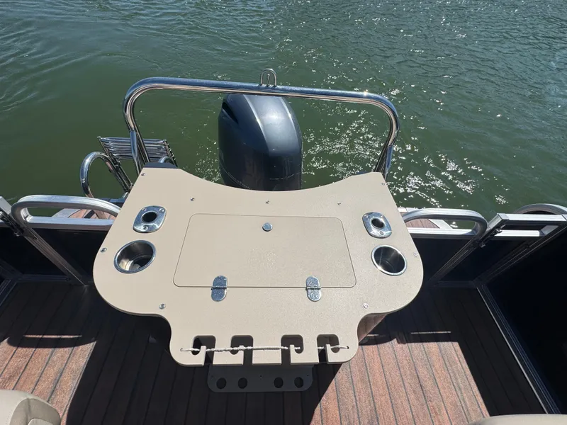 Slide: The Image of 2016 Avalon Catalina 2385 Rear Fish boat with fishing station and motor on water. - 10