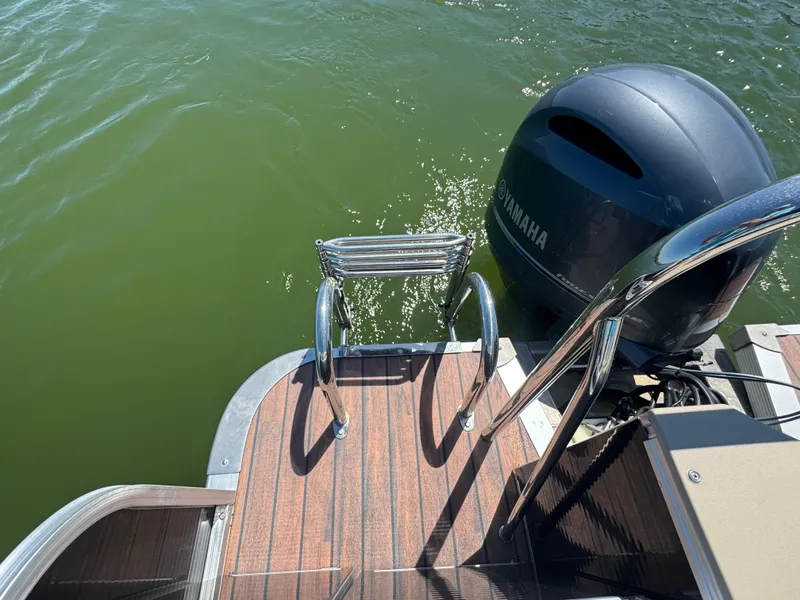 Slide: The Image of 2016 Avalon Catalina 2385 Rear Fish boat with Yamaha motor and swim ladder. - 12