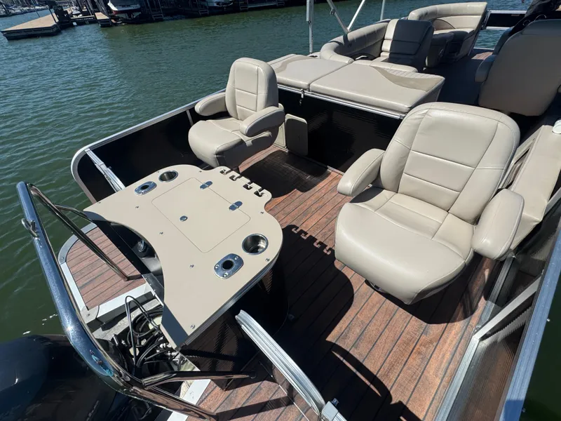 Slide: The Image of 2016 Avalon Catalina 2385 Rear Fish boat with beige seating and fishing station on a lake. - 13