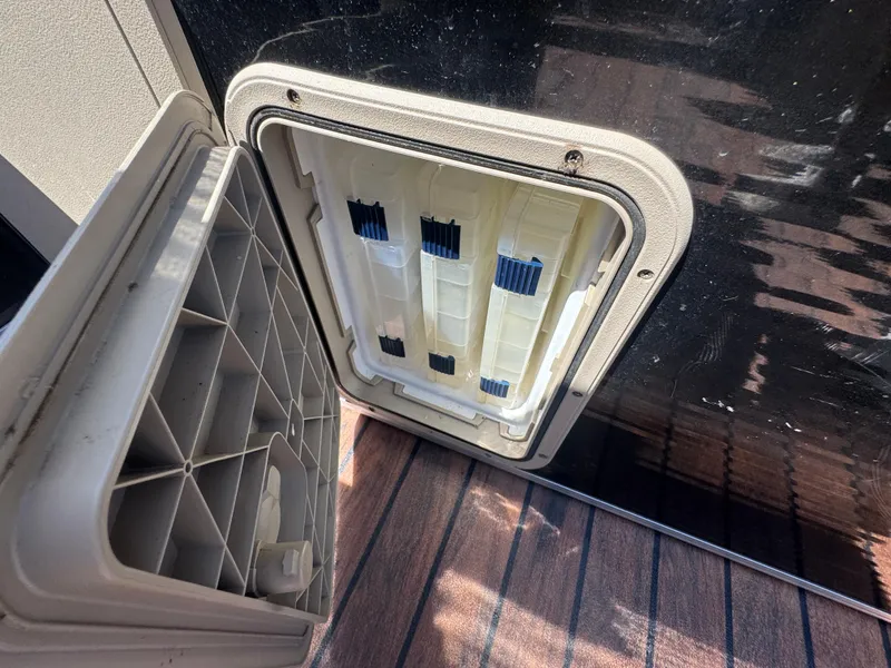 Slide: The Image of Open storage compartment on 2016 Avalon Catalina 2385 Rear Fish boat, showing interior details. - 15