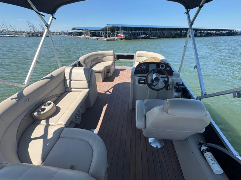 Slide: The Image of 2016 Avalon Catalina 2385 Rear Fish pontoon boat interior with seating and steering wheel. - 18