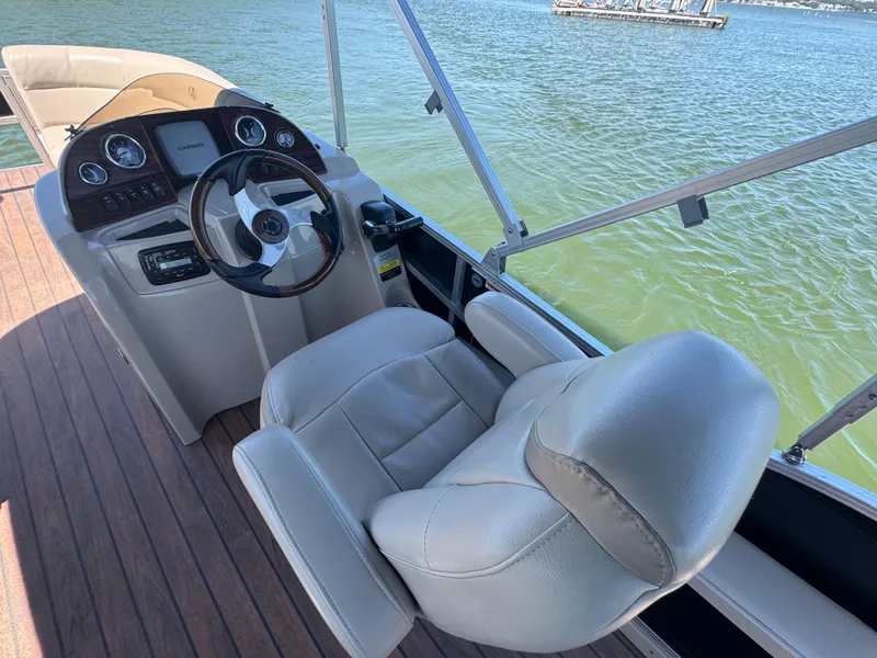 Slide: The Image of 2016 Avalon Catalina 2385 Rear Fish boat helm with leather seat and steering wheel. - 19
