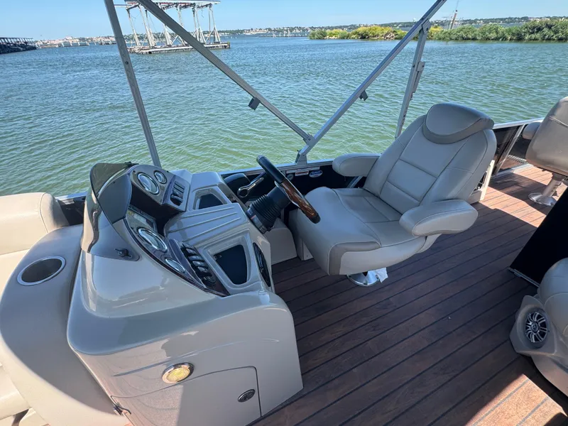 Slide: The Image of 2016 Avalon Catalina 2385 Rear Fish boat interior with captain's chair and control panel. - 21