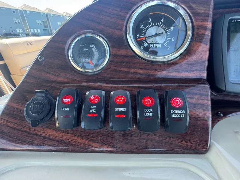 Slide: The Image of Control panel of 2016 Avalon Catalina 2385 Rear Fish boat with switches and RPM gauge. - 25