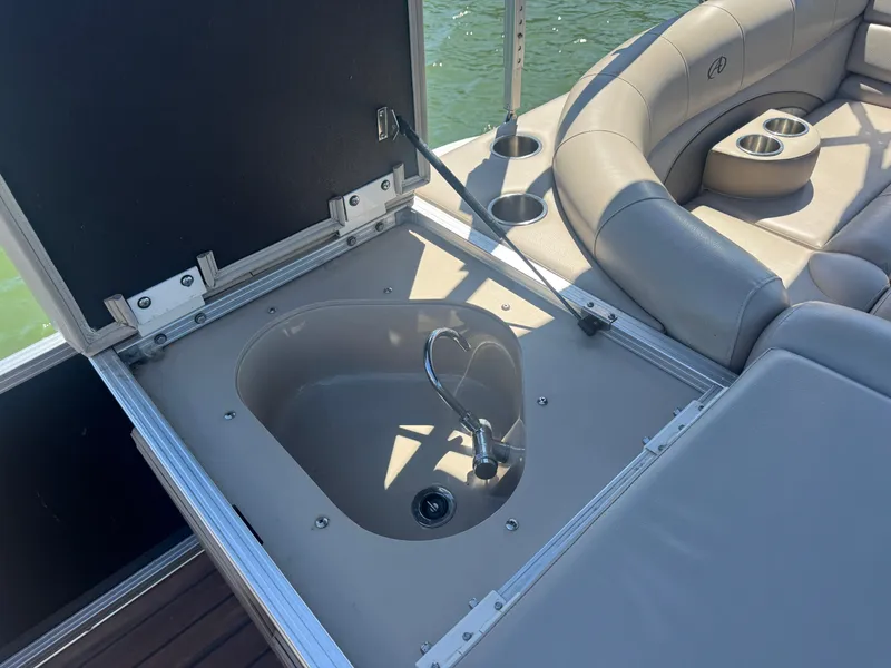 Slide: The Image of 2016 Avalon Catalina 2385 Rear Fish boat with open storage compartment and seating. - 27