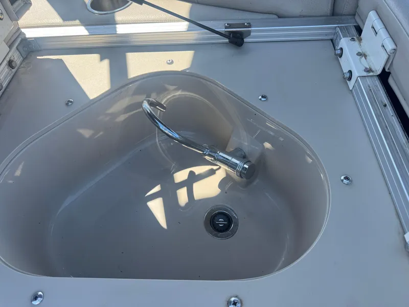 Slide: The Image of 2016 Avalon Catalina 2385 Rear Fish boat sink with faucet in sunlight. - 28