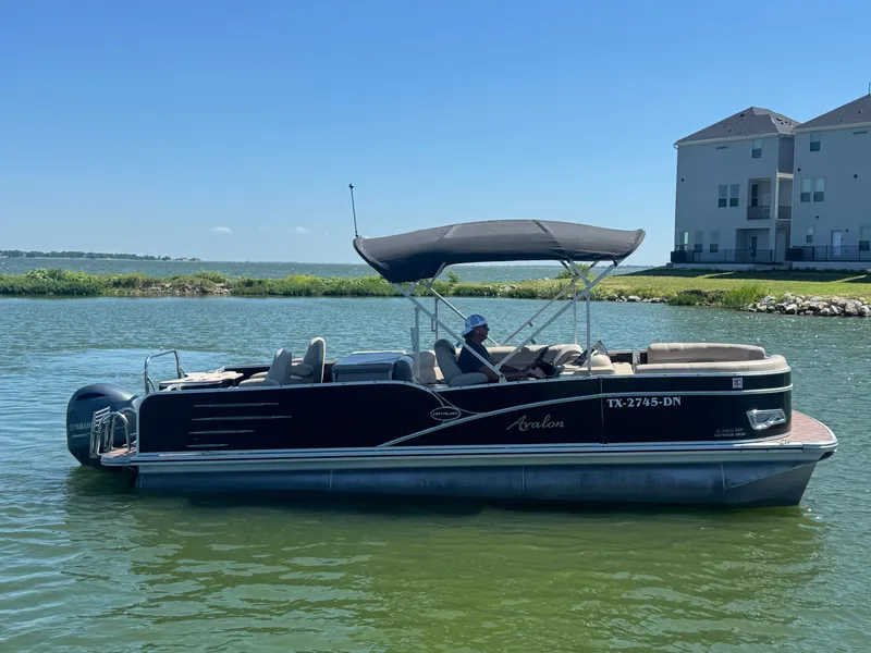 Slide: The Image of 2016 Avalon Catalina 2385 Rear Fish pontoon boat on a lake, sunny day. - 5