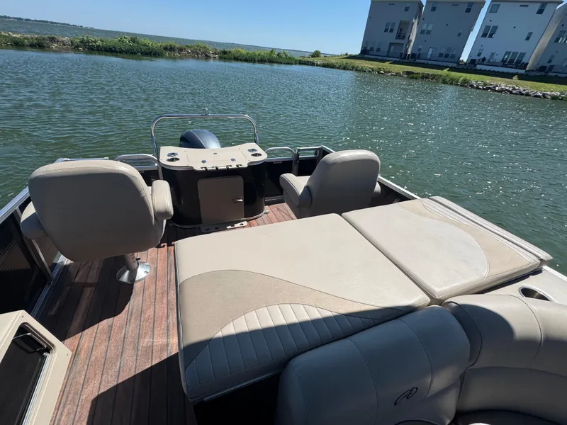 Slide: The Image of 2016 Avalon Catalina 2385 Rear Fish pontoon boat on a serene lake. - 8