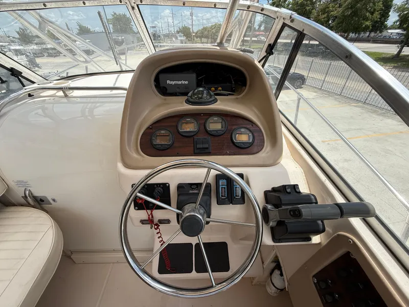 Slide: The Image of 1997 Grady-White F-26 Tigercat boat dashboard with steering wheel and gauges. - 10