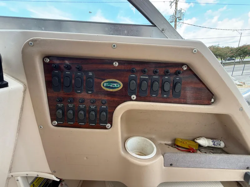 Slide: The Image of Control panel of a 1997 Grady-White F-26 Tigercat boat with labeled switches. - 11