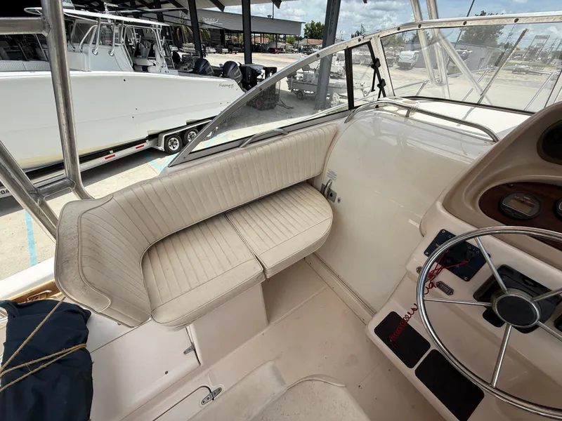 Slide: The Image of 1997 Grady-White F-26 Tigercat boat interior with seating and steering wheel. - 12