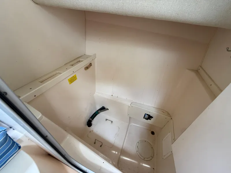 Slide: The Image of 1997 Grady-White F-26 Tigercat interior cabin space, featuring a compact, clean design. - 18