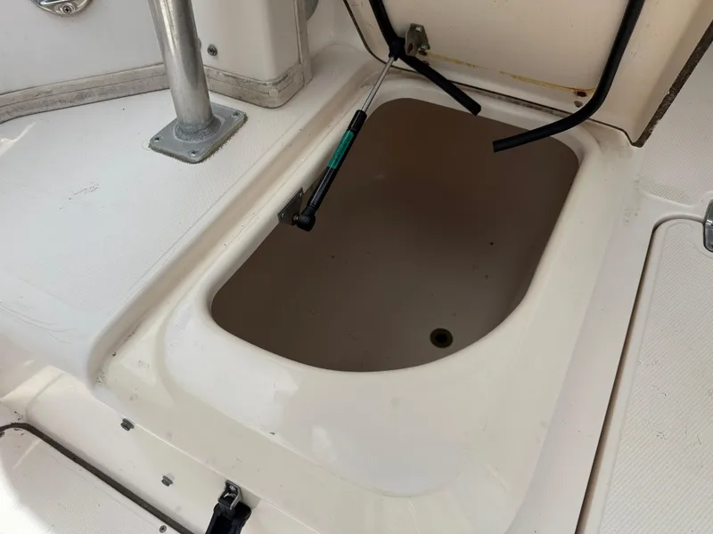 Slide: The Image of Open storage compartment on a 1997 Grady-White F-26 Tigercat boat. - 20