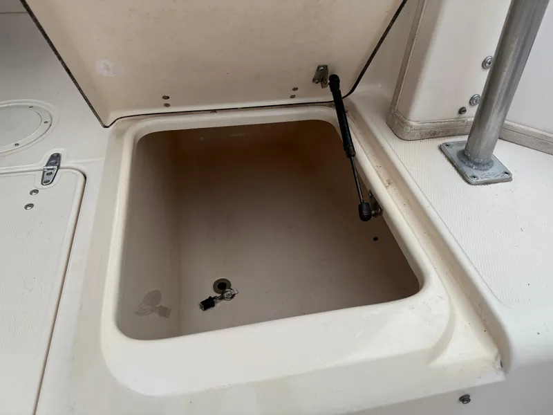 Slide: The Image of Open storage compartment on a 1997 Grady-White F-26 Tigercat boat. - 21