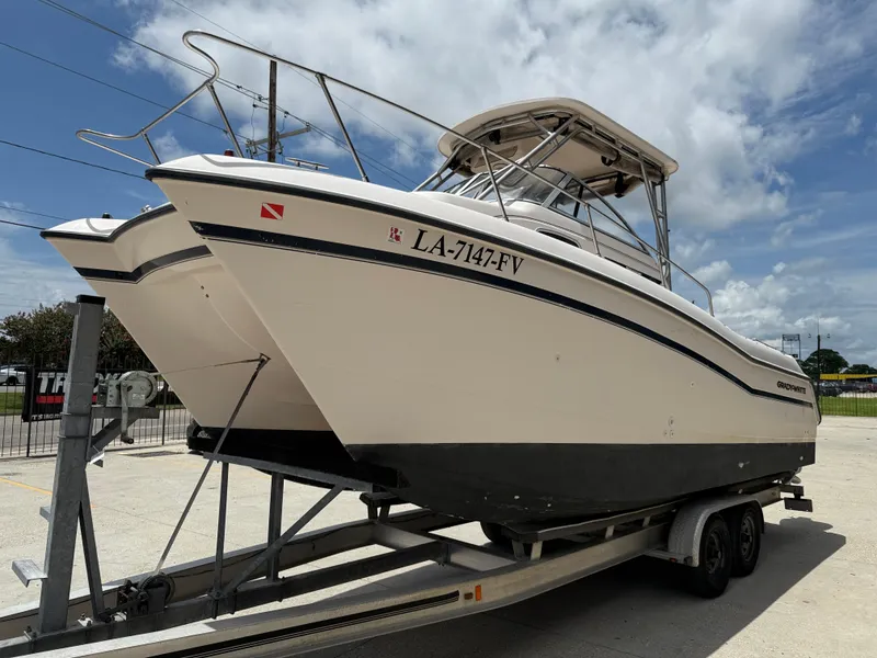 Slide: The Image of 1997 Grady-White F-26 Tigercat boat on trailer under cloudy sky. - 4