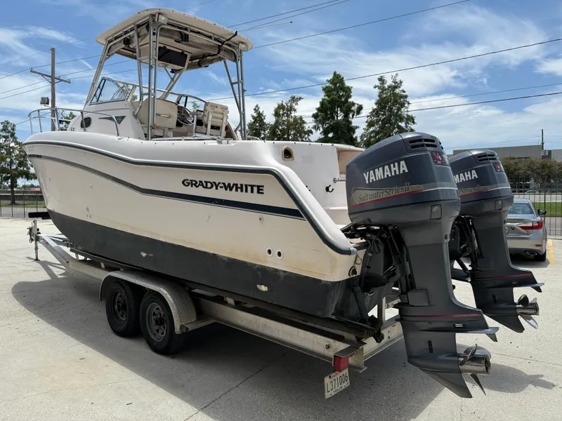 Slide: The Image of 1997 Grady-White F-26 Tigercat boat with twin Yamaha outboard motors on a trailer. - 5