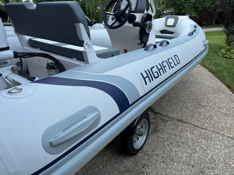 Slide: The Image of 2023 Highfield Classic 420 inflatable boat on a trailer, featuring sleek design and steering console. - 4