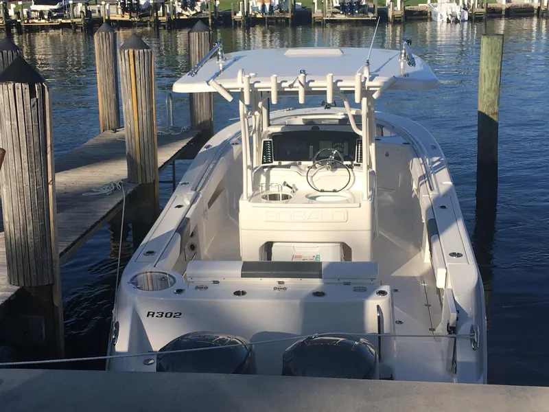 Slide: The Image of 2018 Robalo R302 Center Console boat docked at marina. - 1