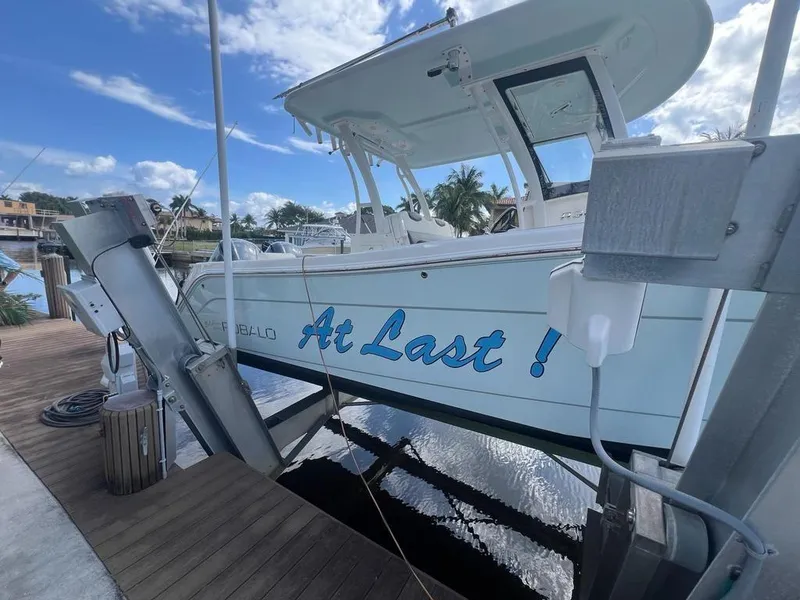 Slide: The Image of 2018 Robalo R302 Center Console boat docked, featuring "At Last!" text on the side. - 16