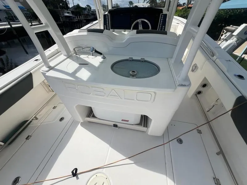 Slide: The Image of 2018 Robalo R302 Center Console boat interior with helm and seating area. - 18