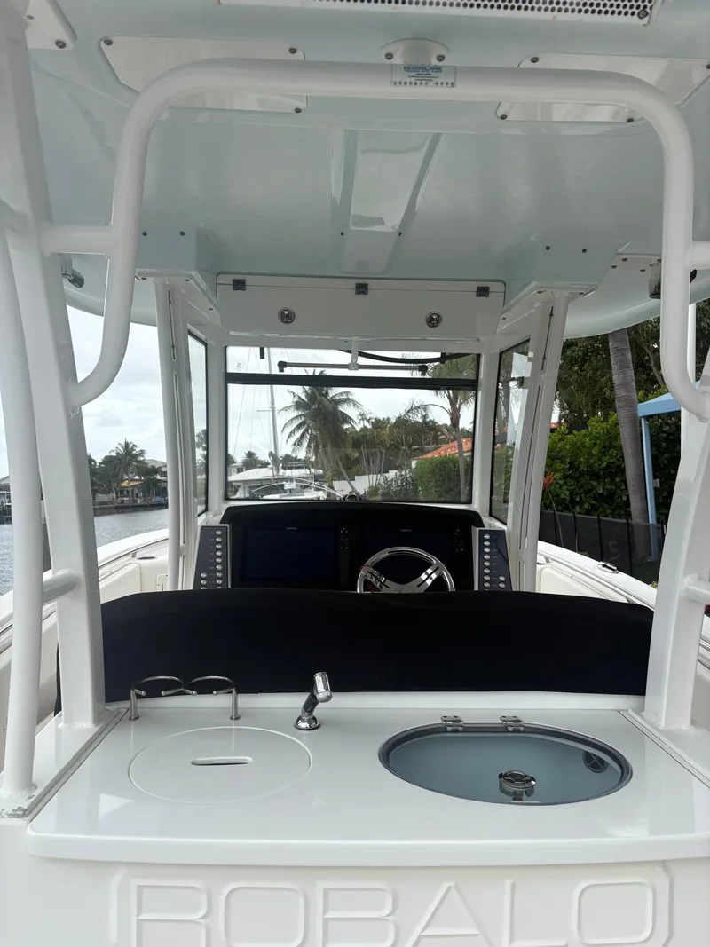 Slide: The Image of 2018 Robalo R302 Center Console boat interior with steering wheel and control panel. - 22