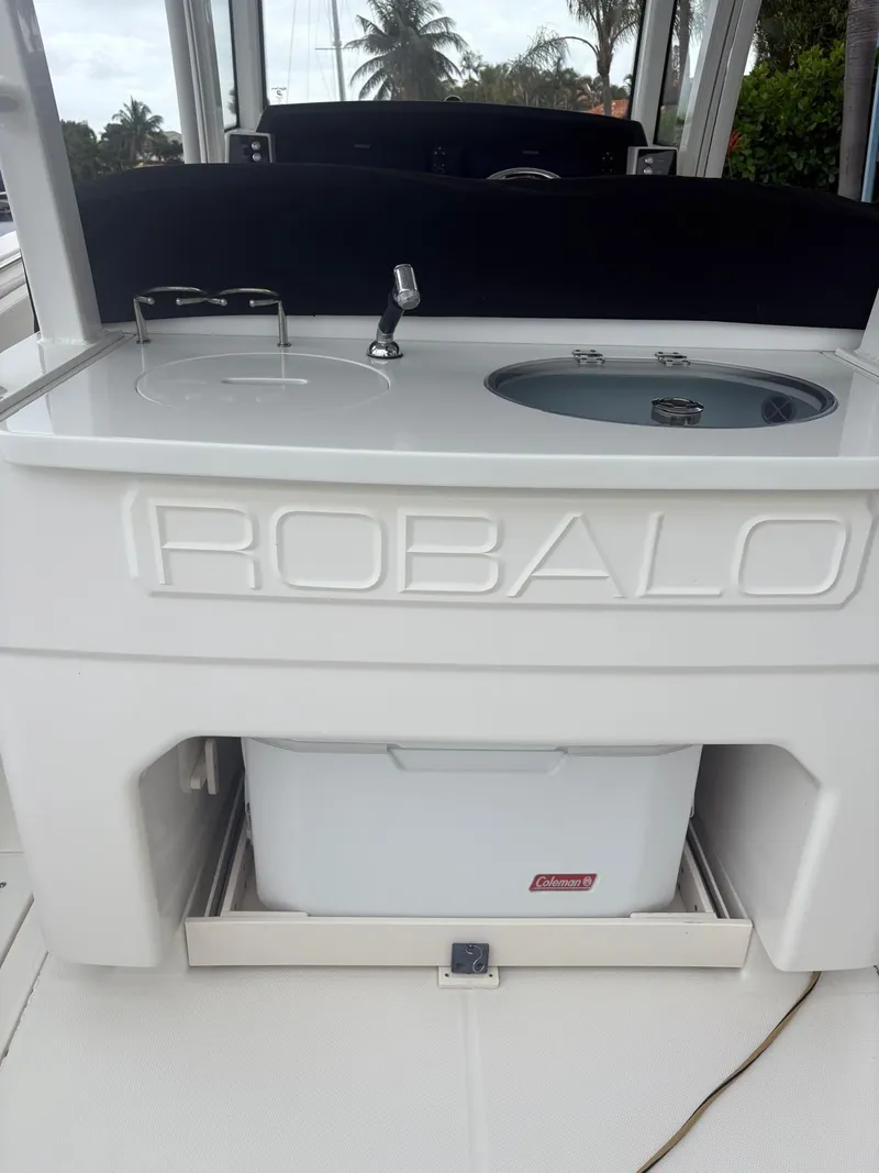 Slide: The Image of 2018 Robalo R302 Center Console boat with integrated sink and storage compartment. - 23